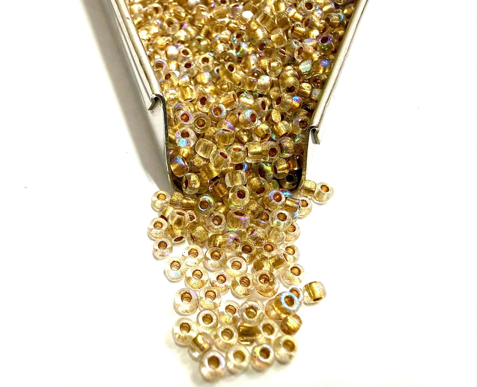 11/0 Charlotte Cut Beads: Patina Dull Gold Lined Aurore Boreale
